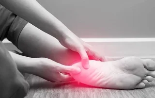 Person holding their painful heel and ankle, highlighting the need for a heel pain specialist in Lakeland Hills Blvd to treat chronic foot pain affecting daily life